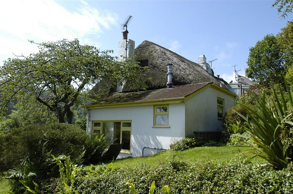 Side exterior and garden showing the sunroom.