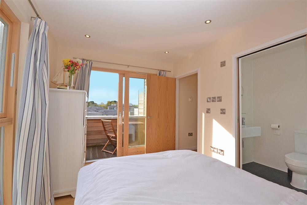 Another view of the master bedroom showing the private balcony