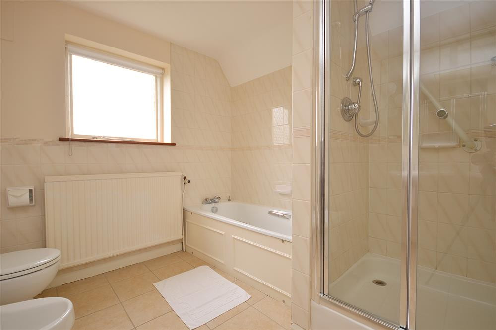 Large first floor family bathroom with separate shower cubicle
