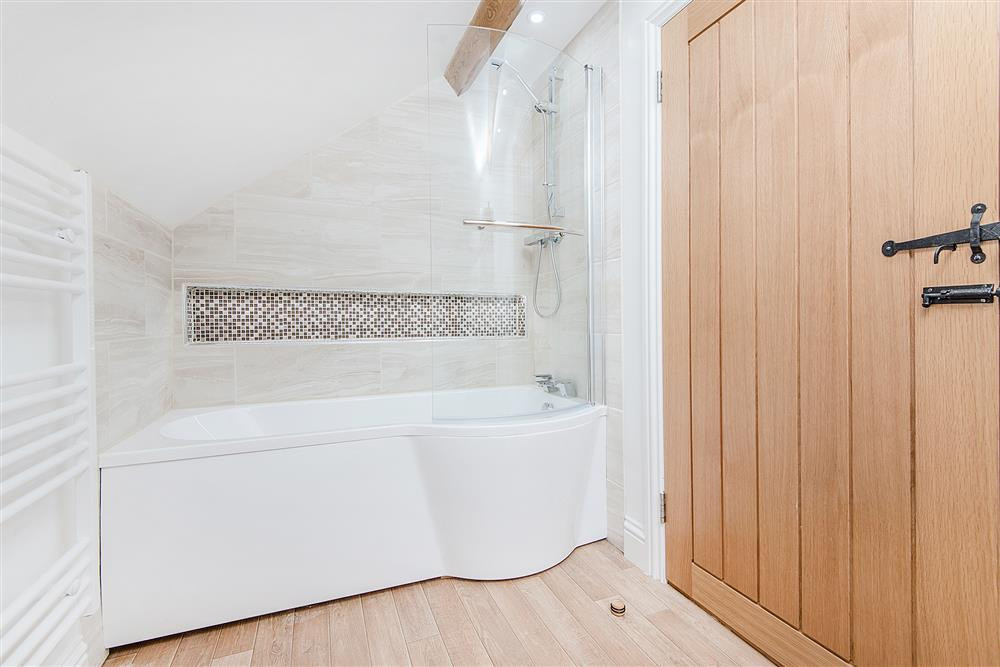 The family bathroom with shower over bath