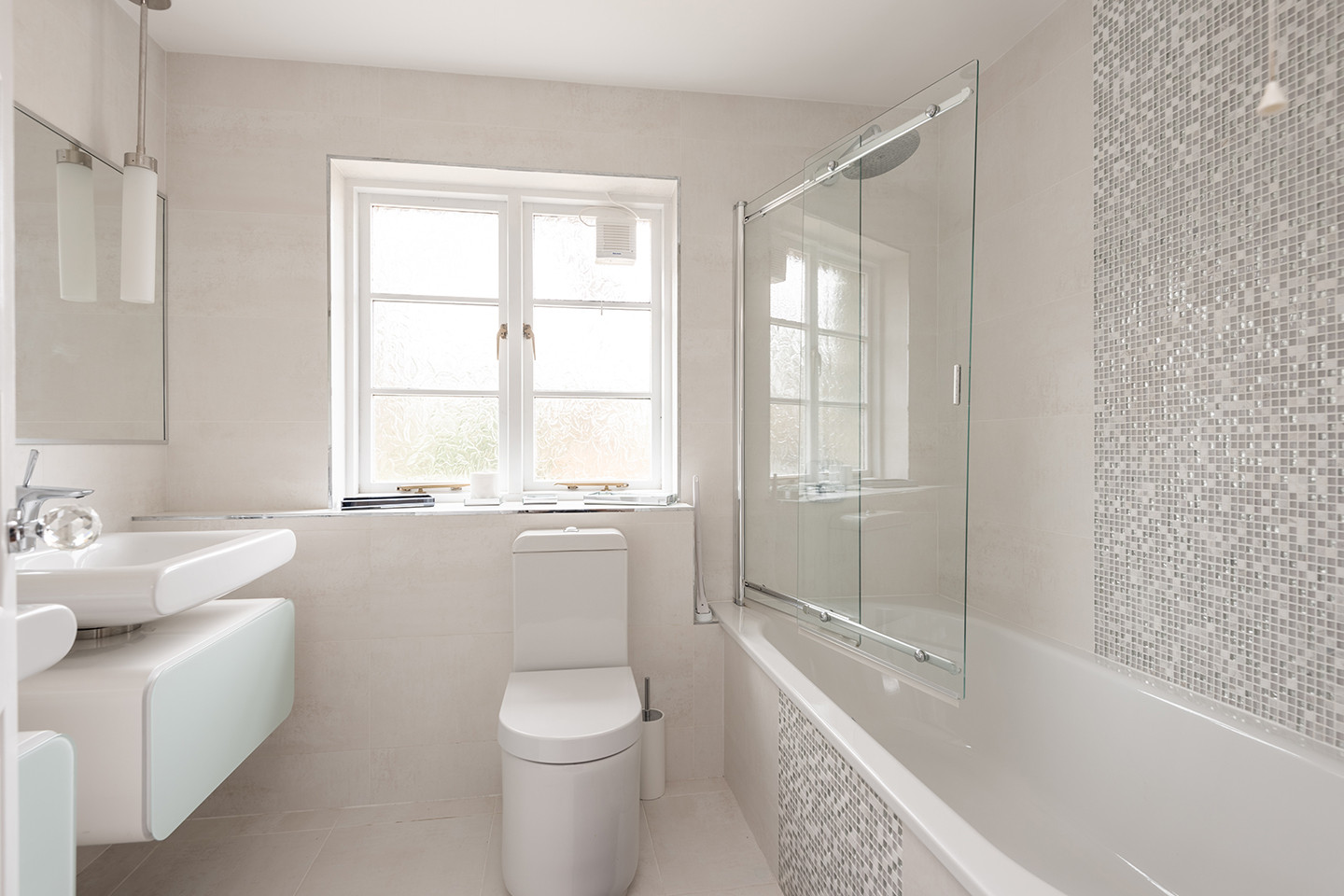 Family bathroom with shower over bath.