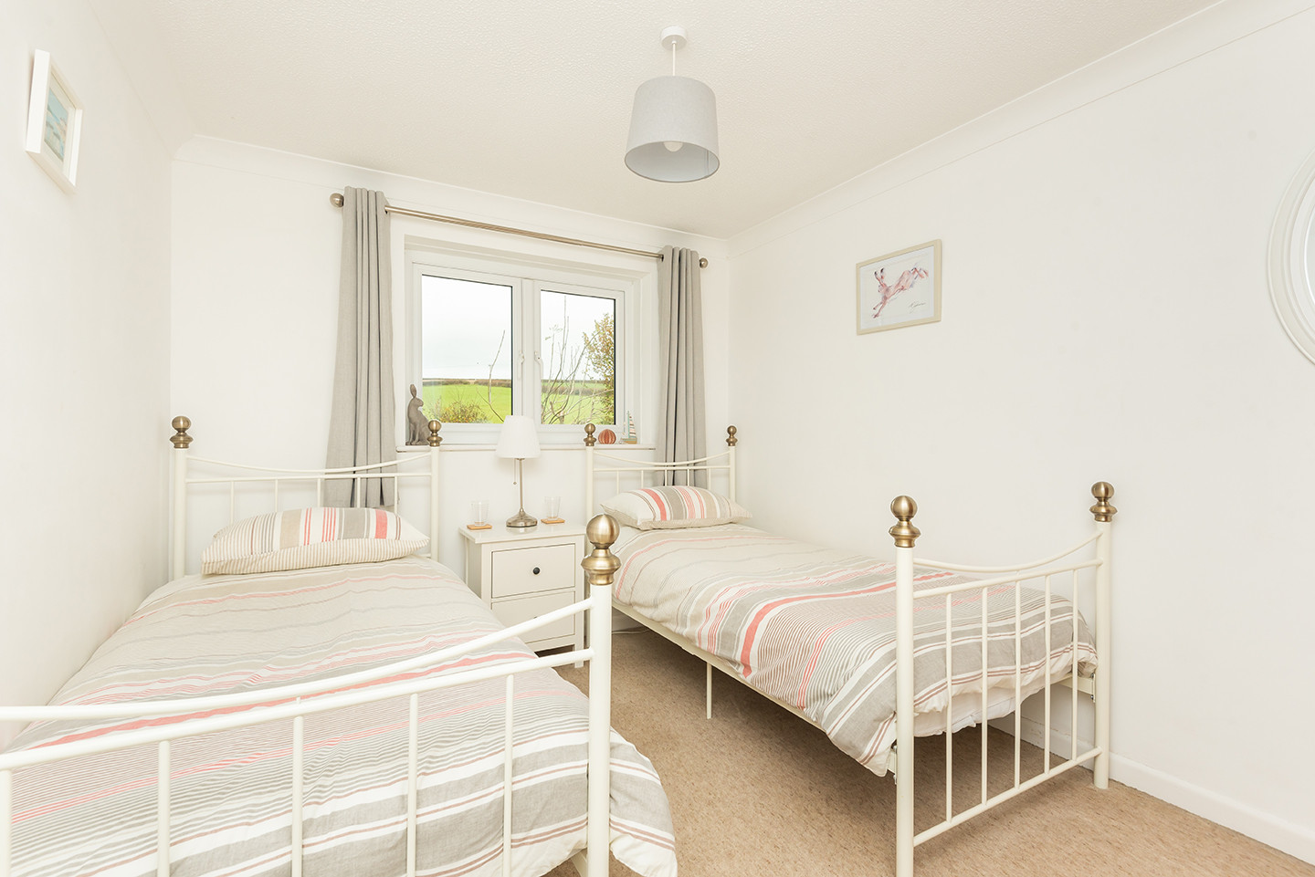 The twin bedroom has views over the rear garden and fields beyond