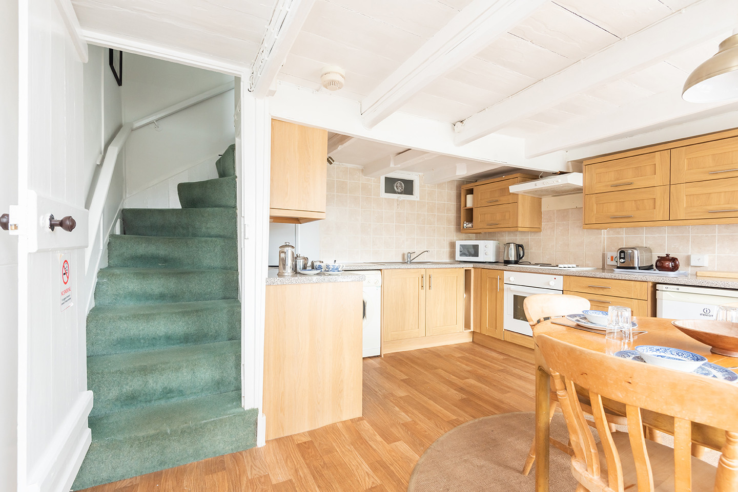 Kitchen - stairs leading up.
