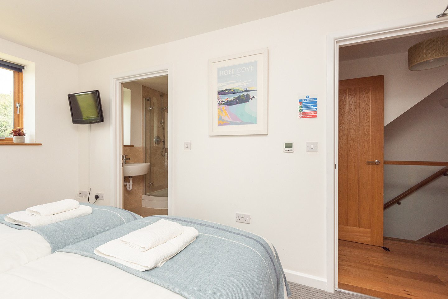 Bedroom 1 with wall-mounted TV and door to ensuite 