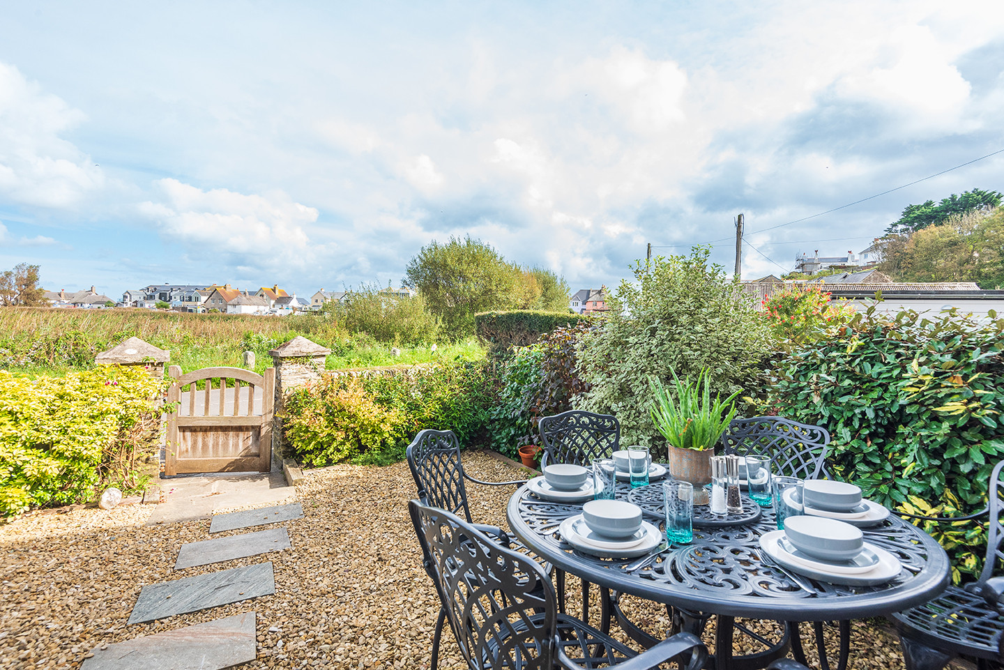 The front garden with table and seating and views over the estuary