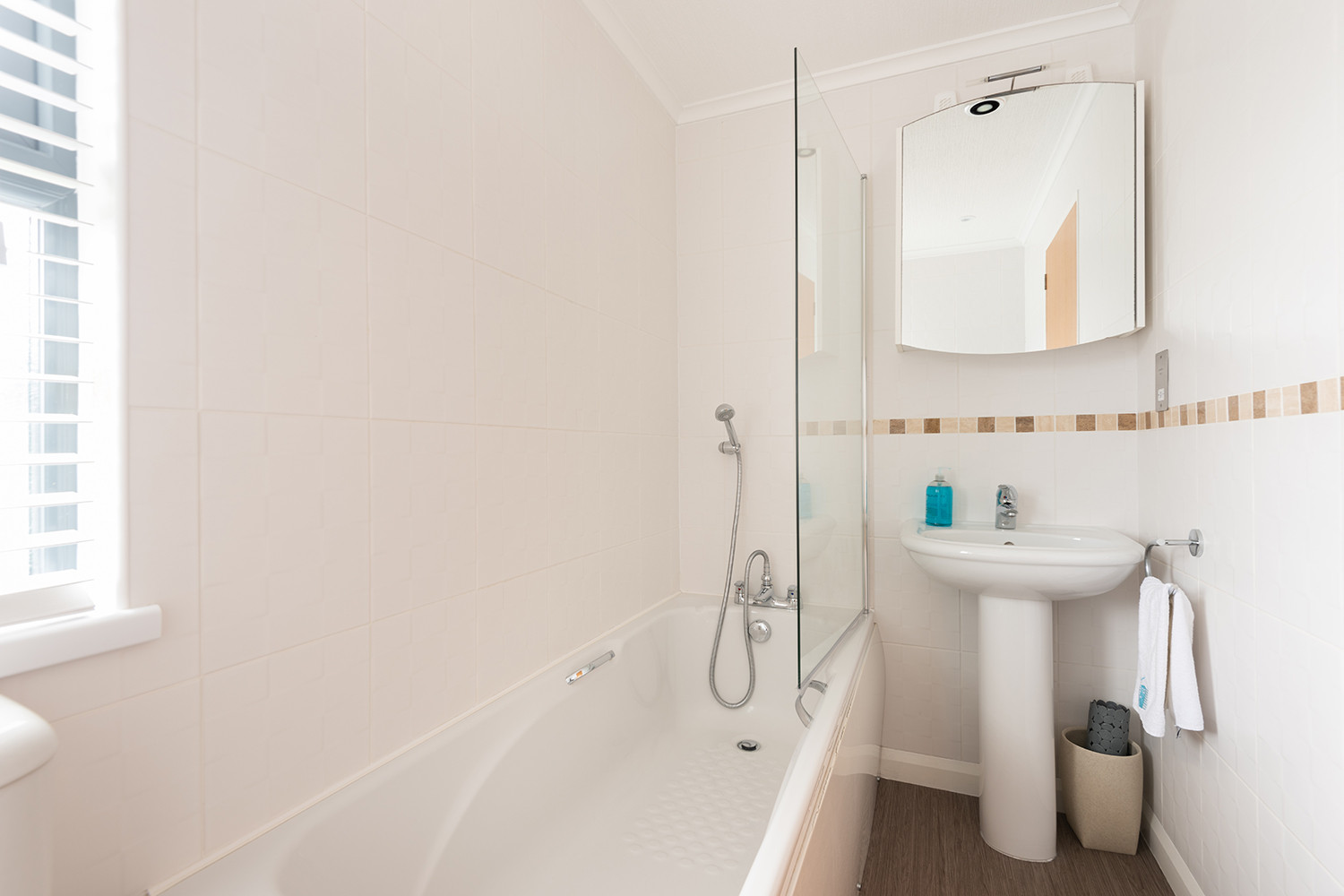 The family bathroom with bath and overhead shower.