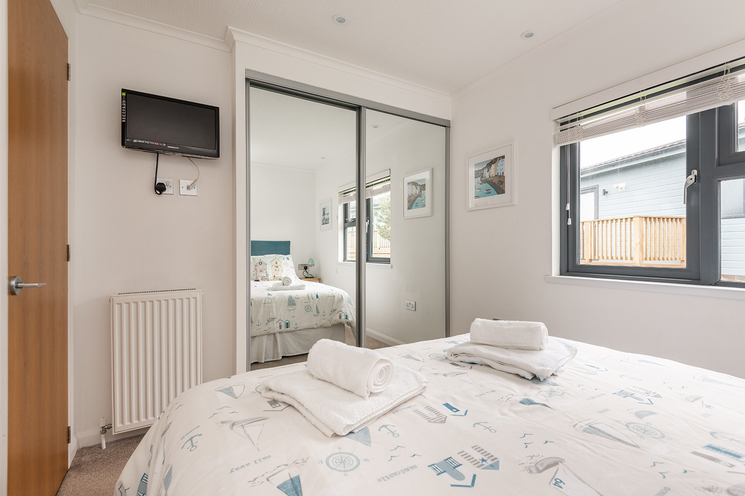 The Master bedroom with large wardrobe and mounted T.V.