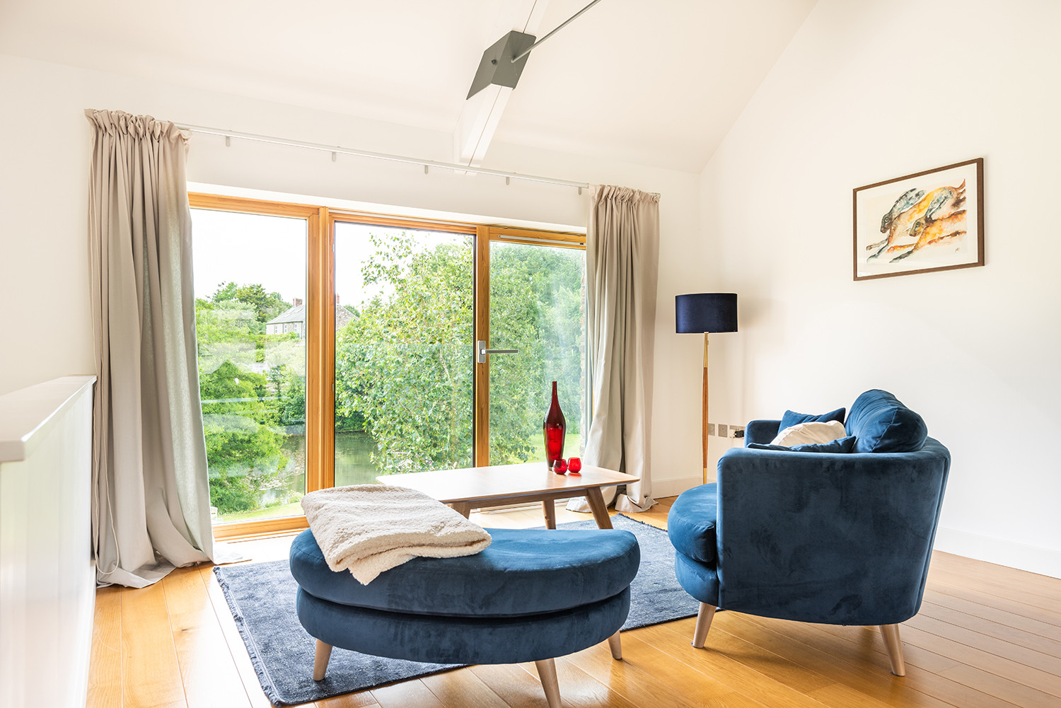 Peaceful additional seating area in the sitting room, overlooking the grounds and lake.