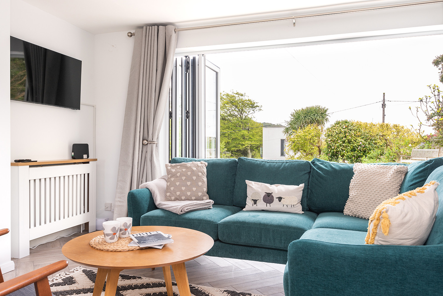The sitting room with bifold doors leading to the terrace.