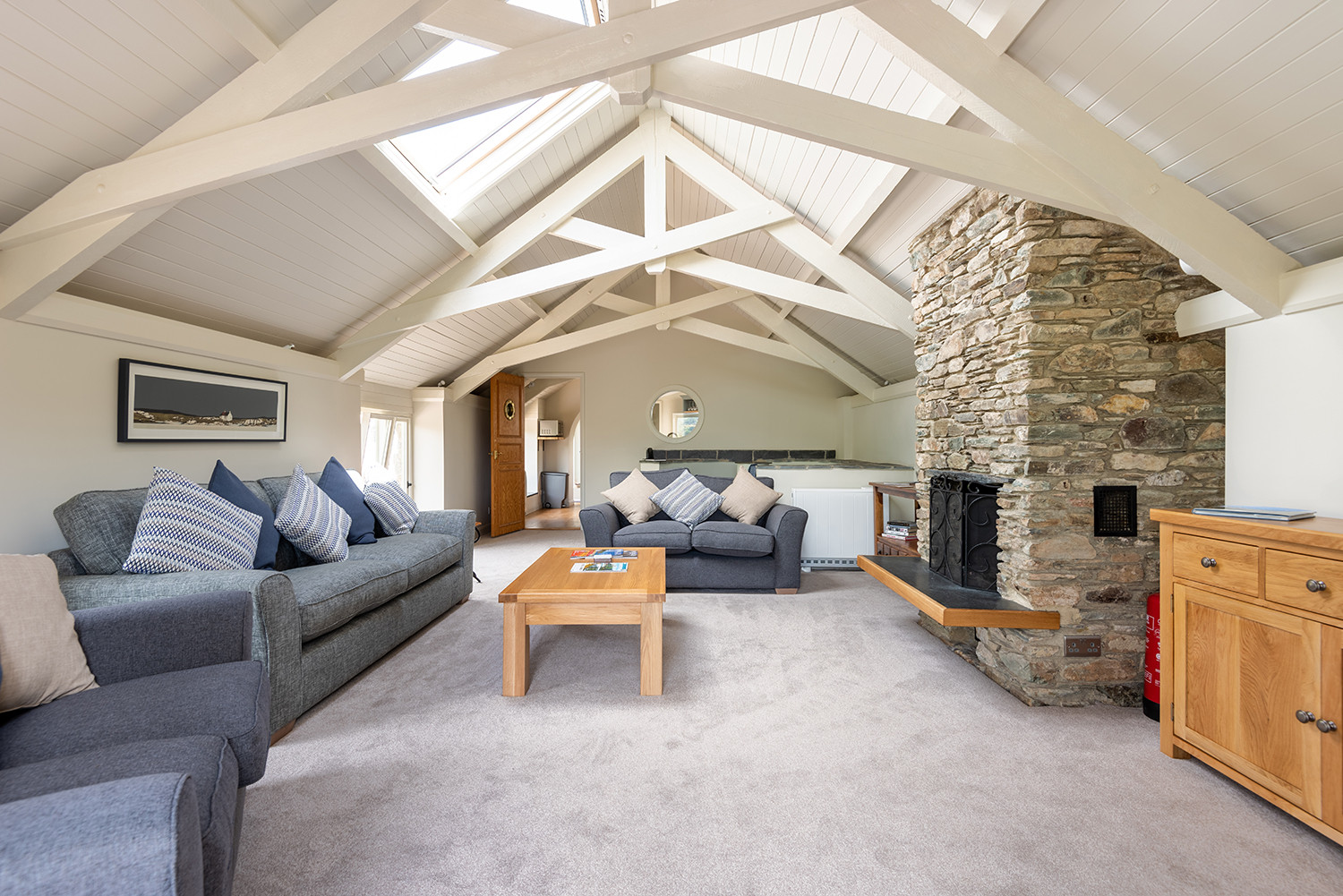 The large lounge, with open fire and feature window to admire the views over the estuary and village.