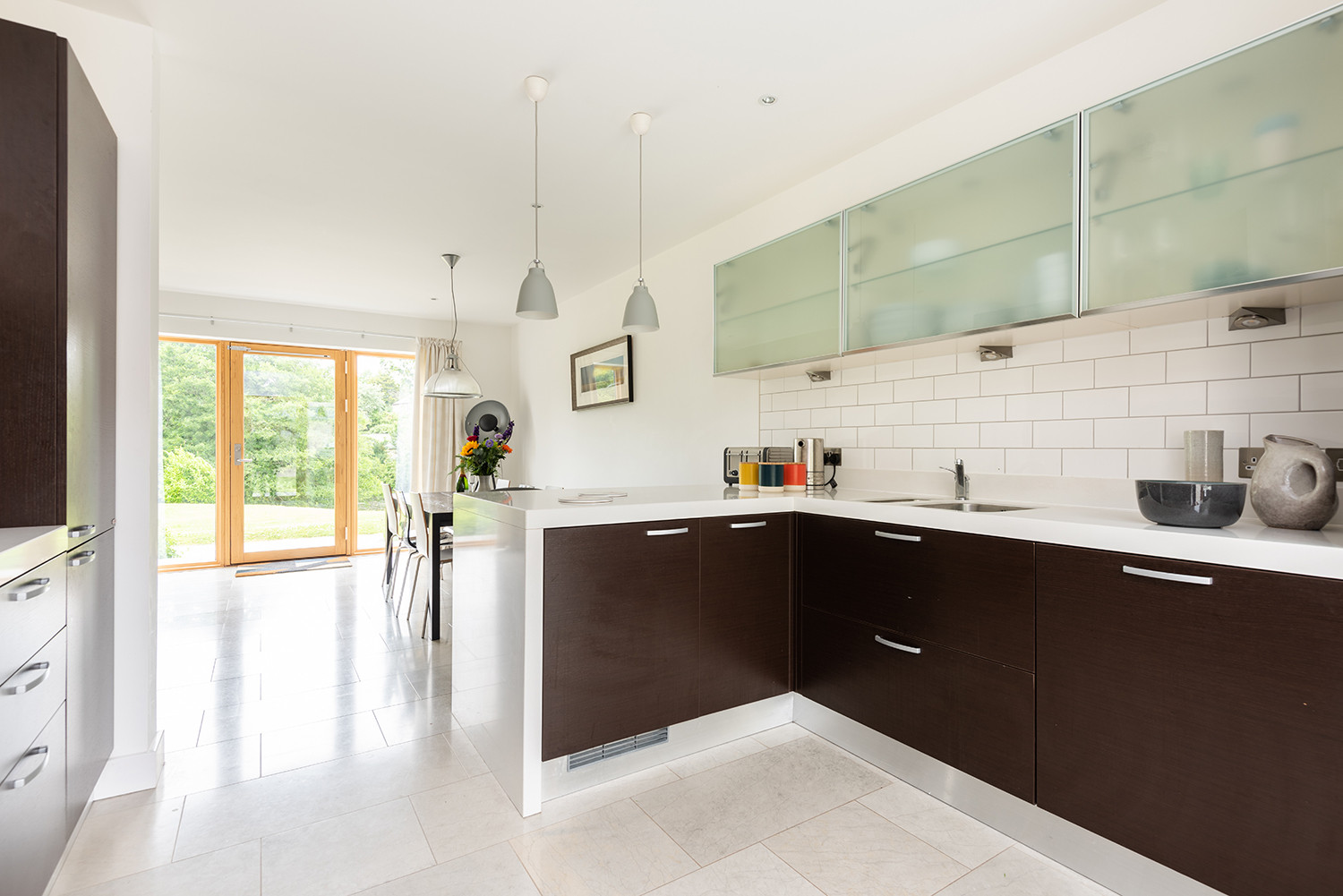 Open-plan kitchen and dining area with views to estate grounds.