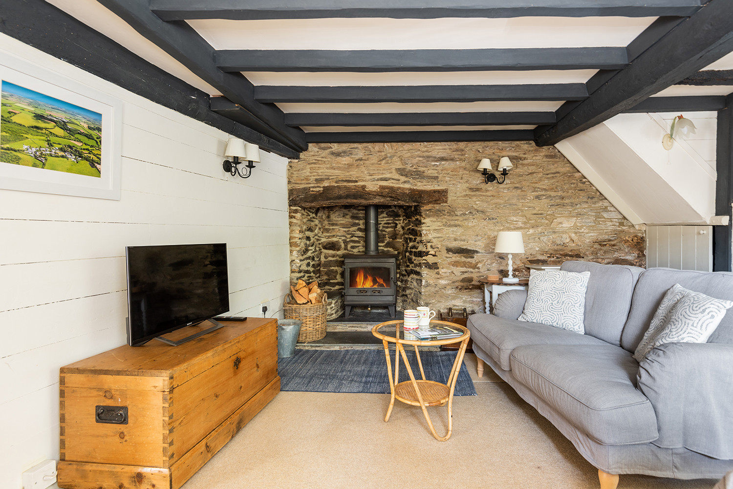 Another view of the quaint fireplace with wood burner