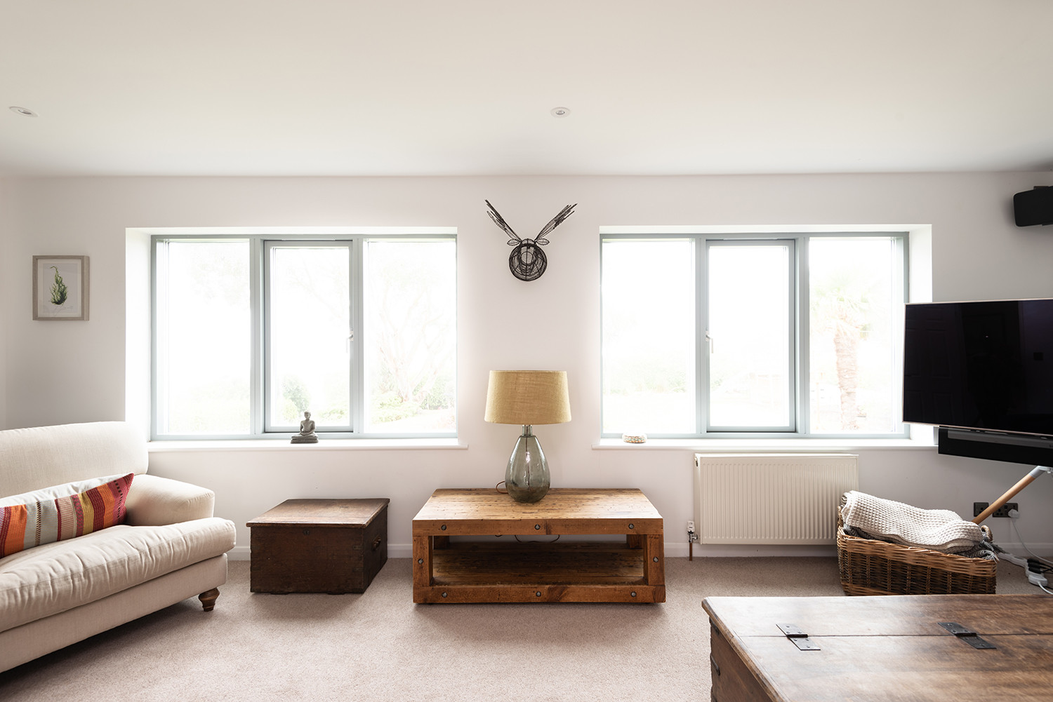The stylish lounge looking out over the lawn at the front to the estuary.
