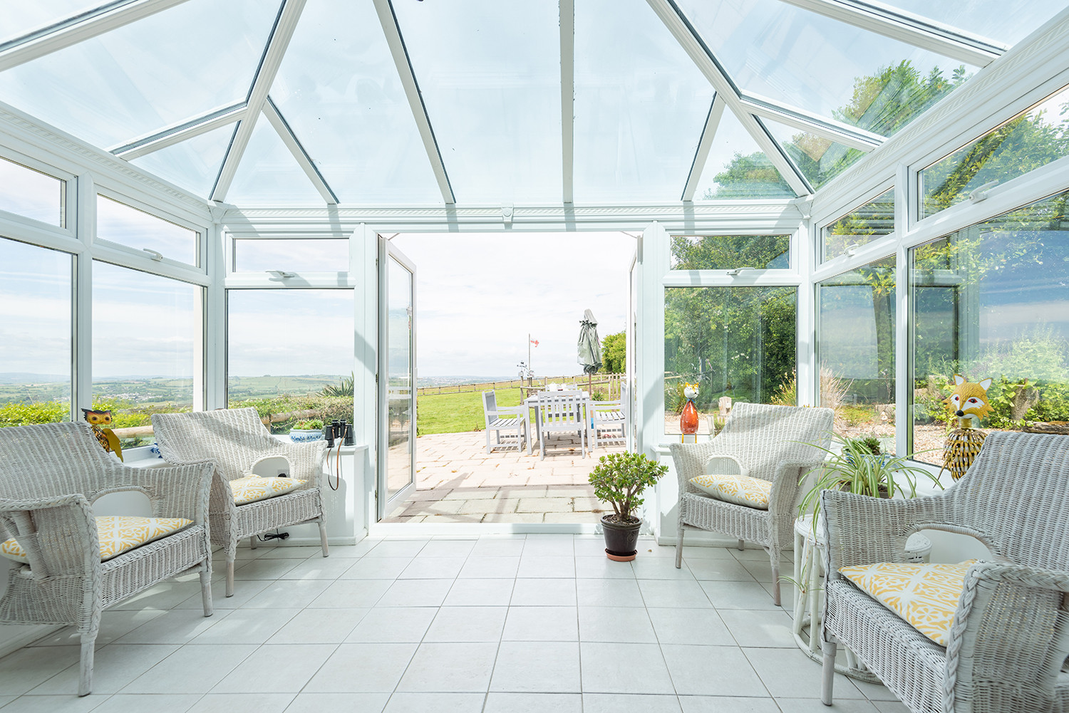 The lovely sunny conservatory with views over the garden and beyond.