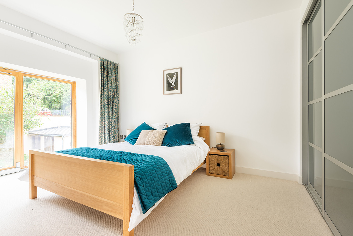 Master bedroom with king size bed and built-in wardrobes.