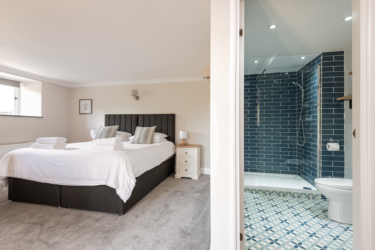 The first ground floor twin/superking bedroom, with cot and en suite shower room.