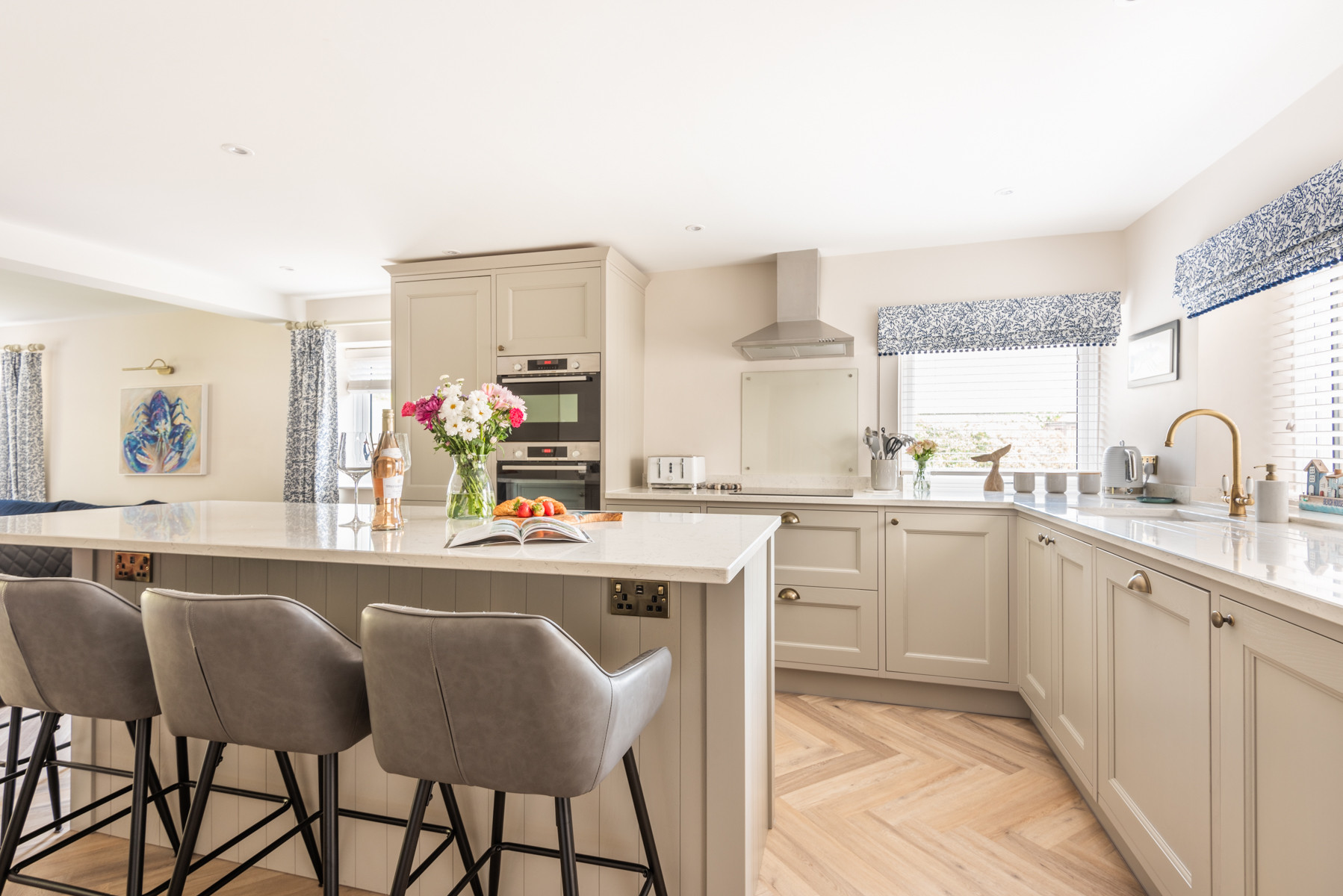 Tasteful open plan living and kitchen area with sociable bar dining