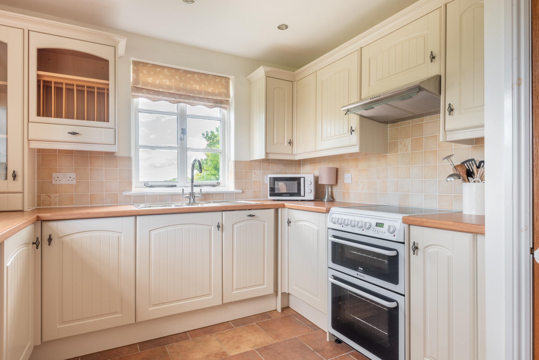 The kitchen is well equipped with plenty of workspace and views!