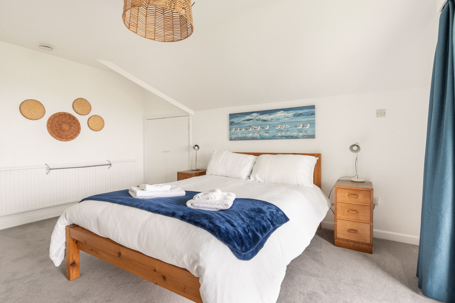 The master bedroom on the first floor with balcony looking over the garden and out over the water beyond