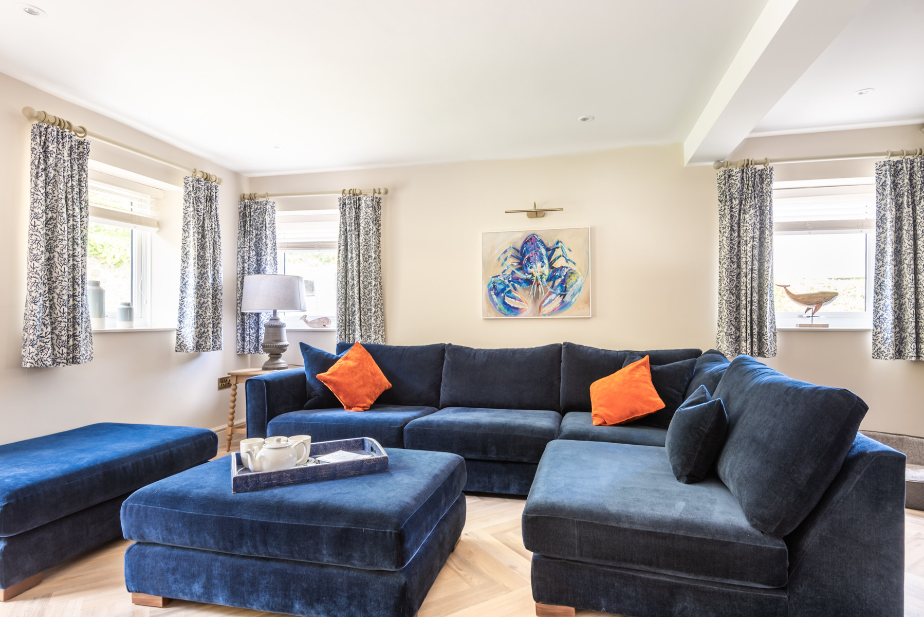 The lounge area has a fantastic sofa with wide seats and pouffes to really cosy up and relax