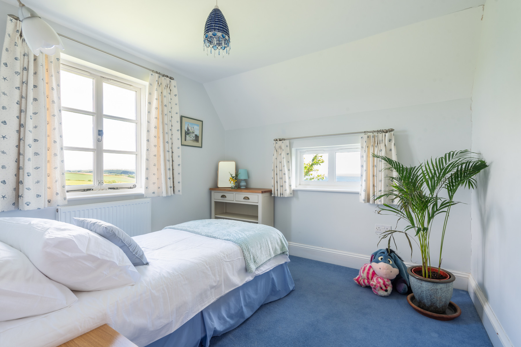 Bedroom 3, with views over the rear garden and out to sea