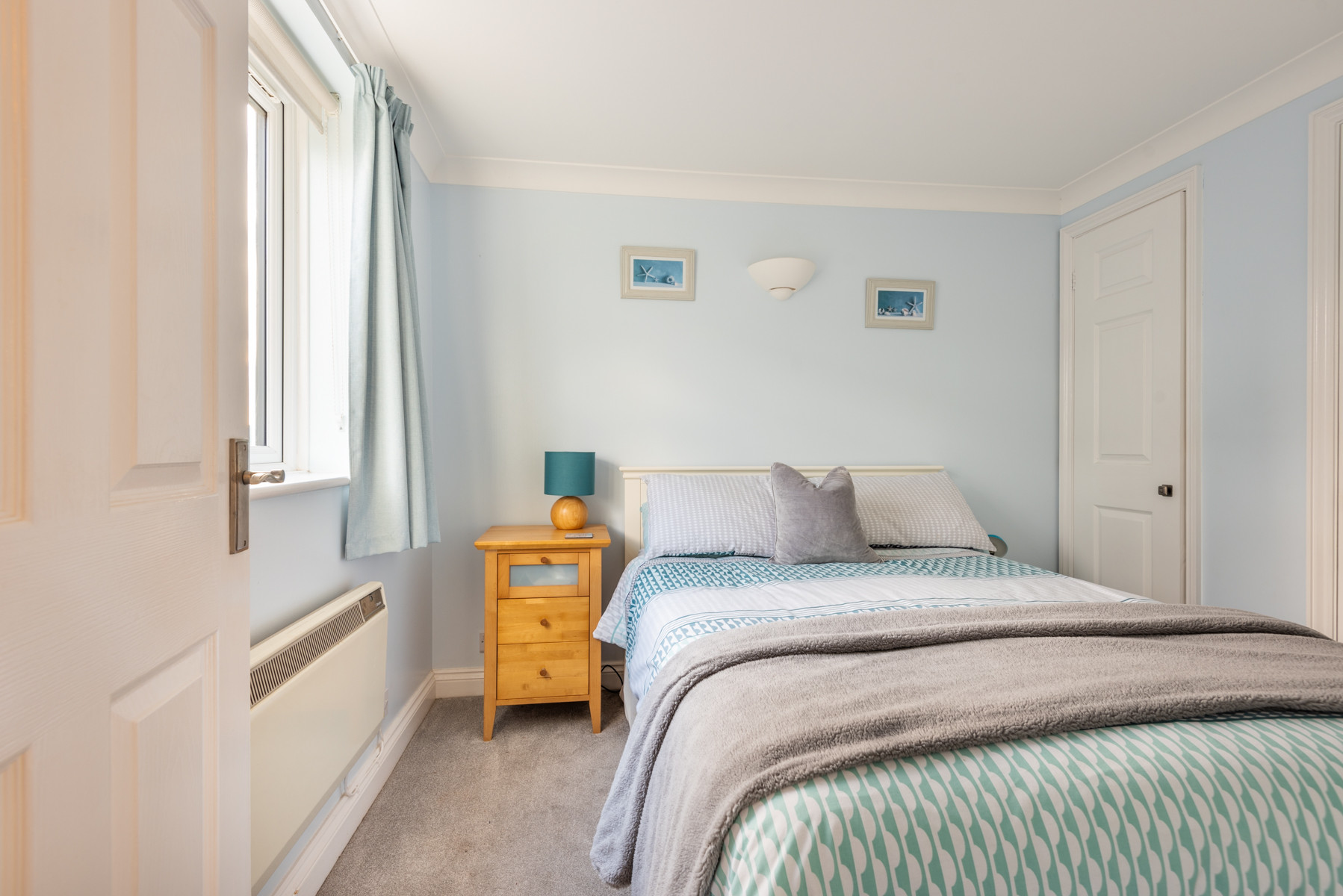 Bedroom one showing the light coming in the window