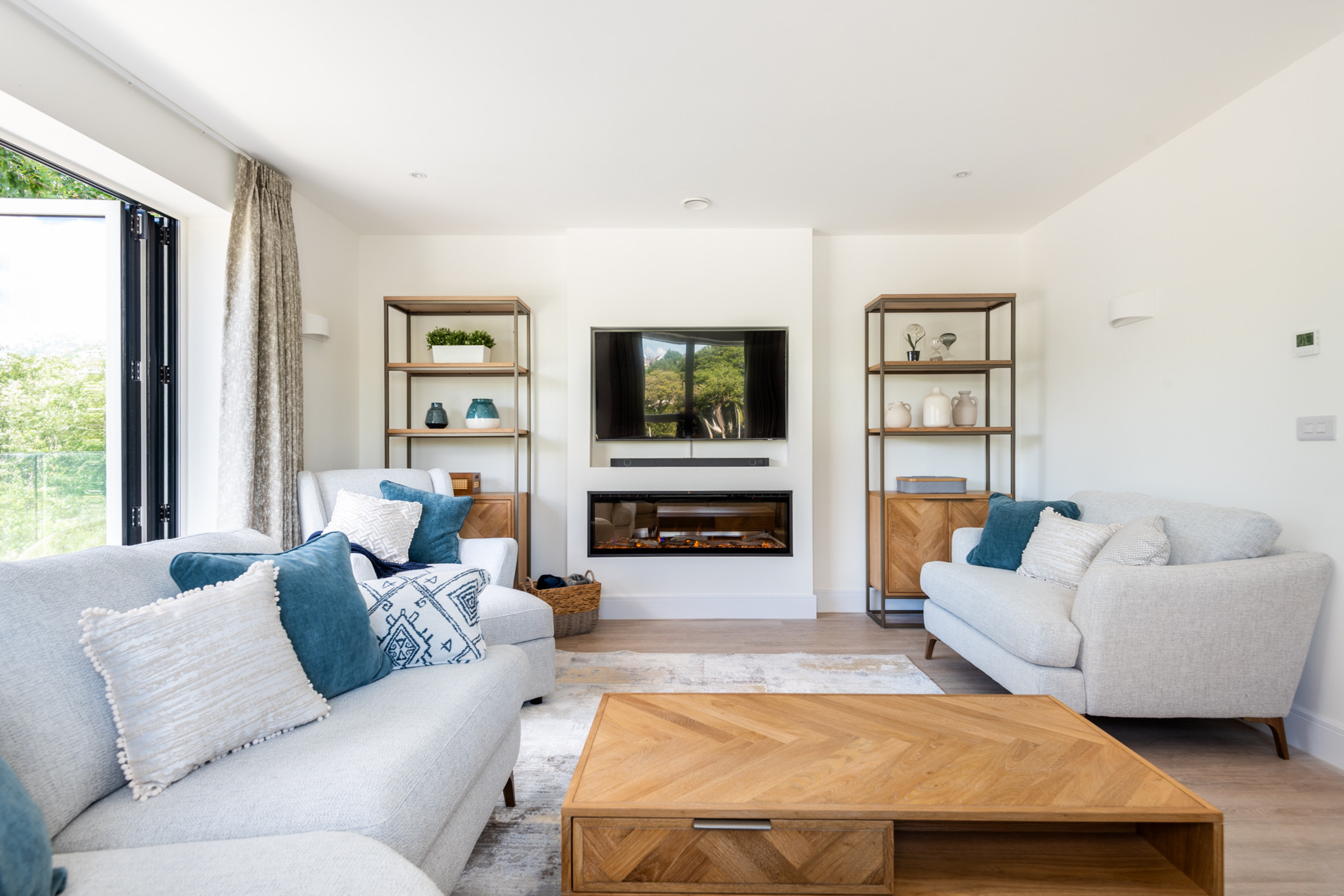 The living room with estuary views, electric feature fire and Smart TV