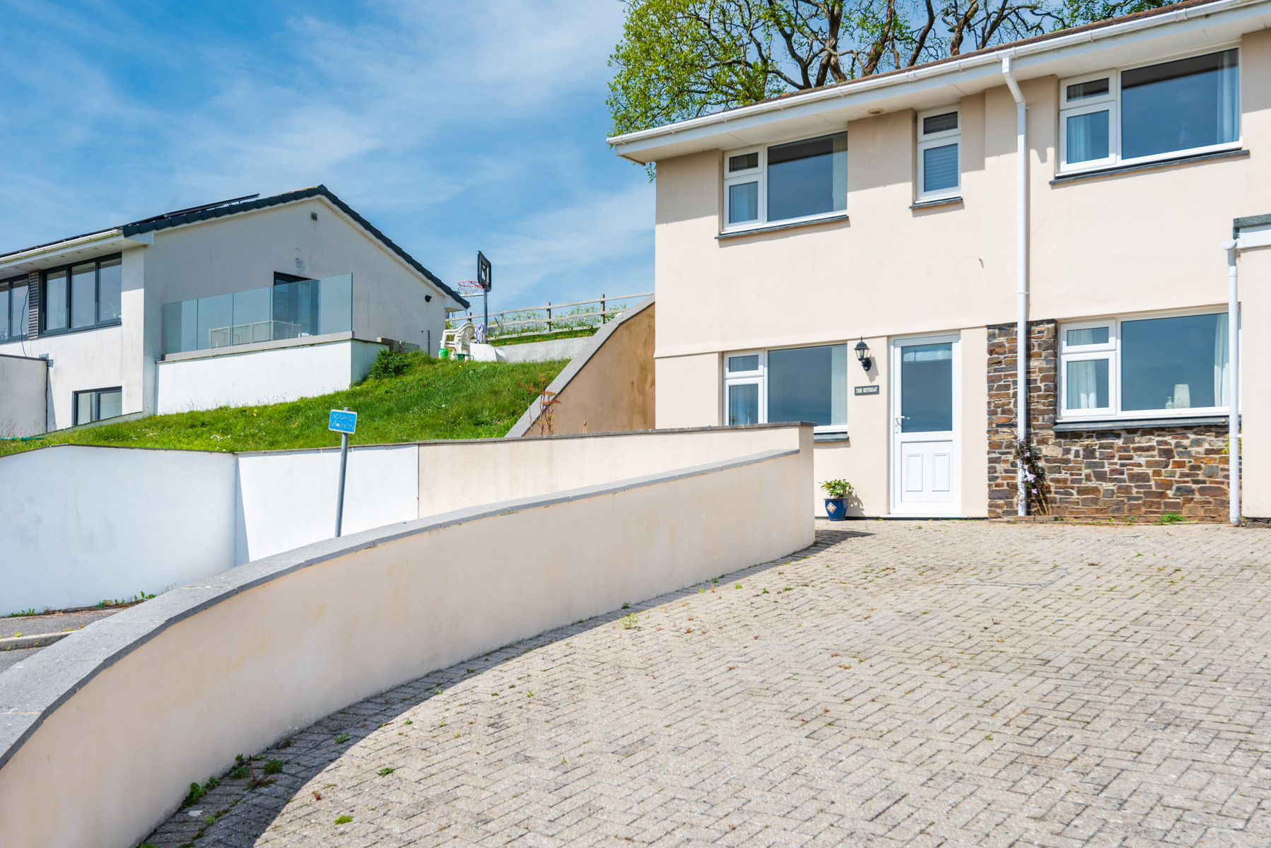 The parking on the left and the retreat is the ground floor apartment in this house