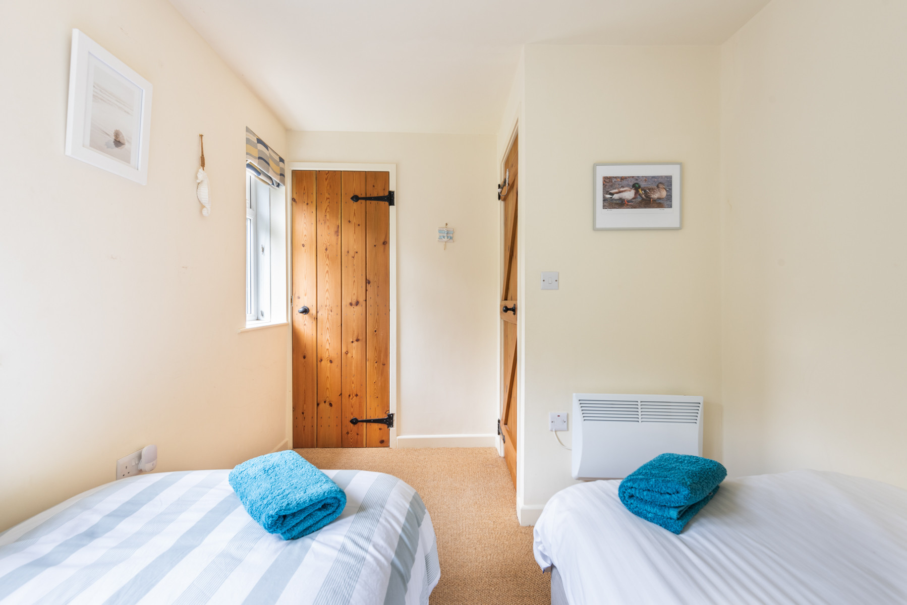 Bedroom 3 with twin beds and garden views
