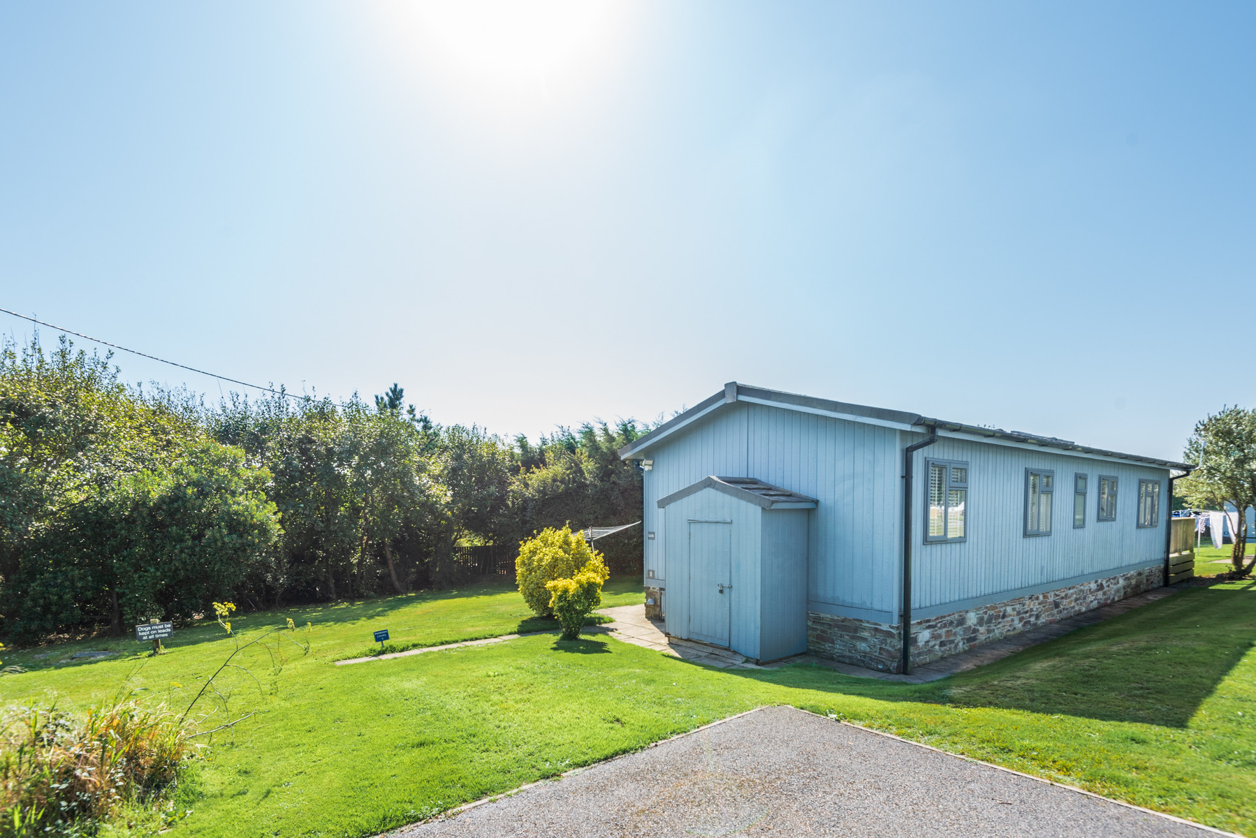 External view of the lodge with lawned area either side of the property.