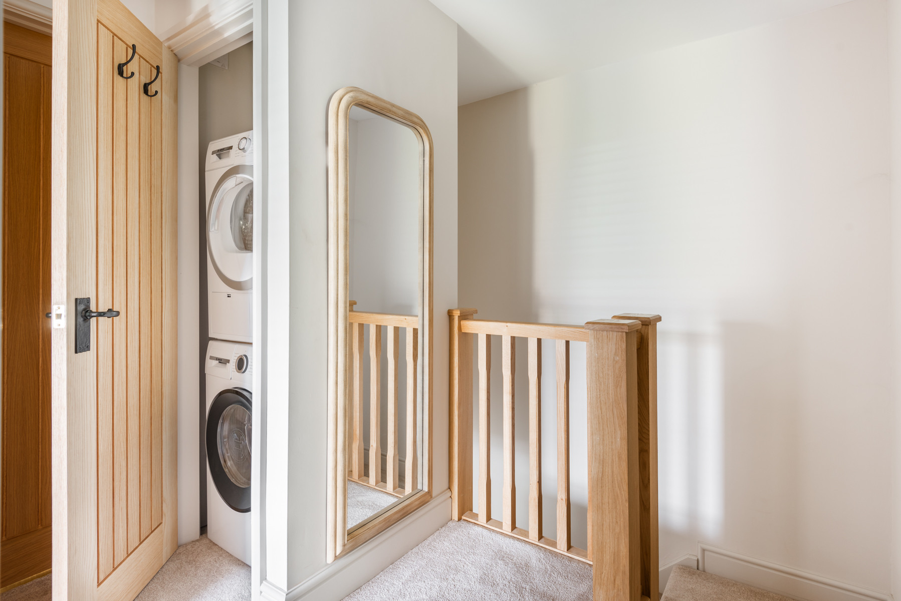 The washer and dryer tucked away in the stairs cupboard