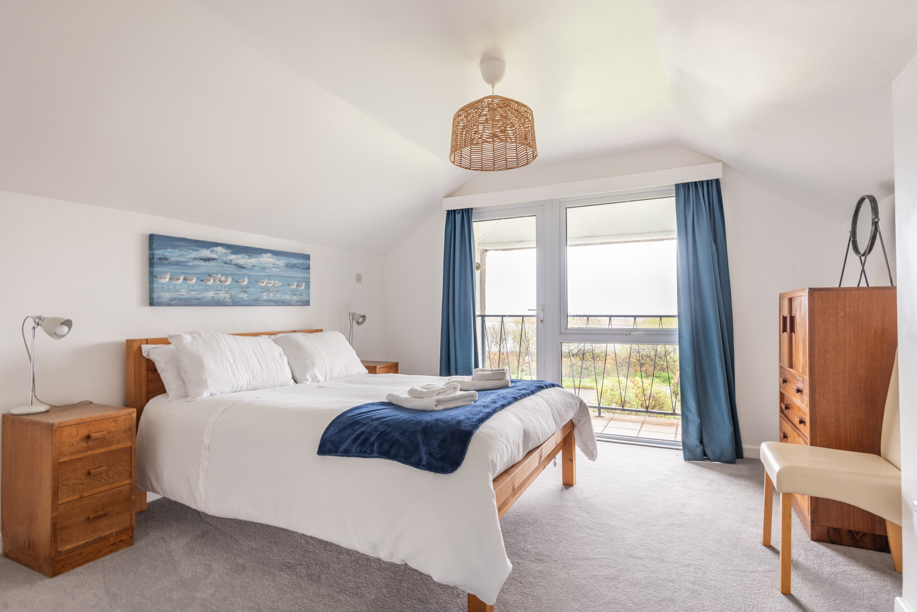 Bedroom 1 on the first floor with balcony and water views