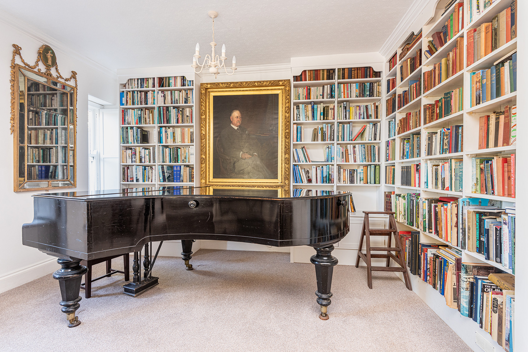 Grand piano and library wall of books in the lounge
