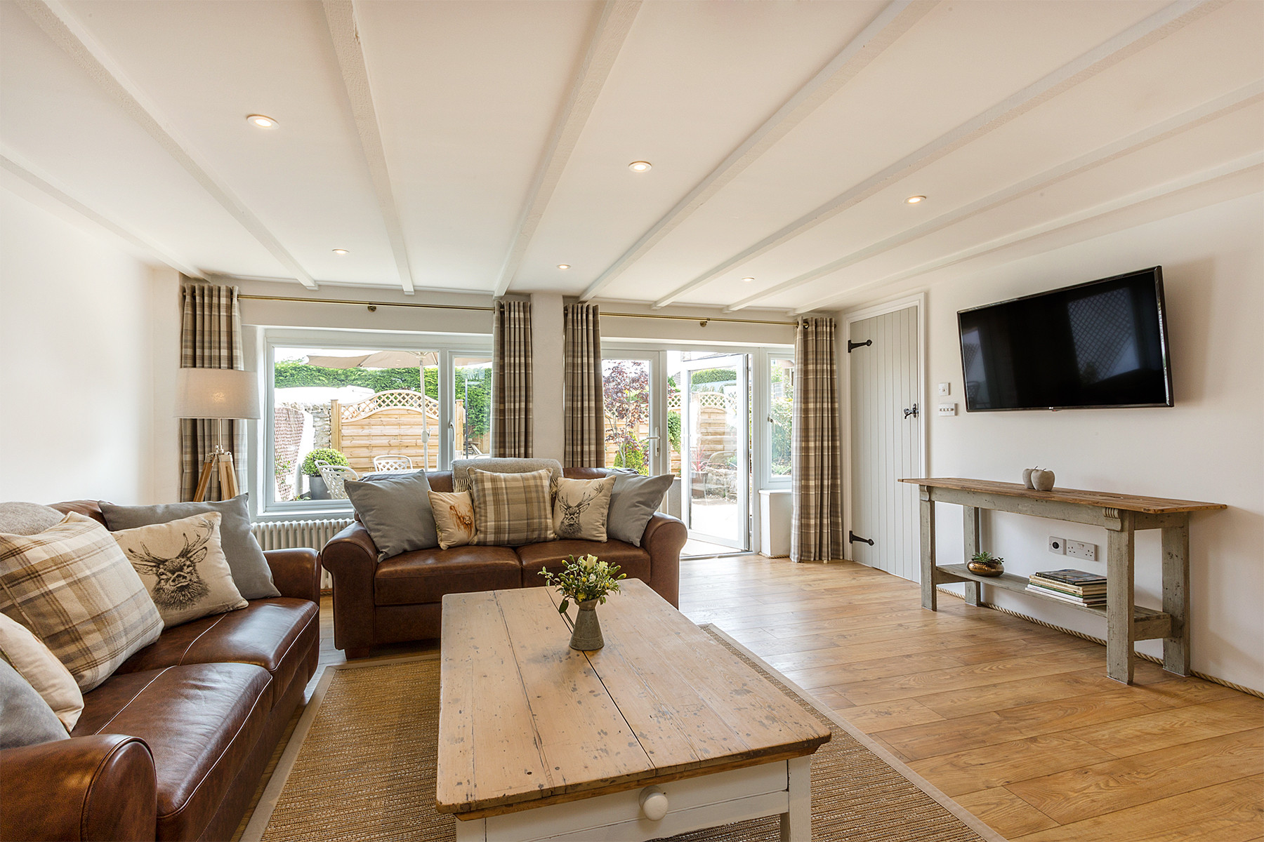The Living room with sofas and large flatscreen tv