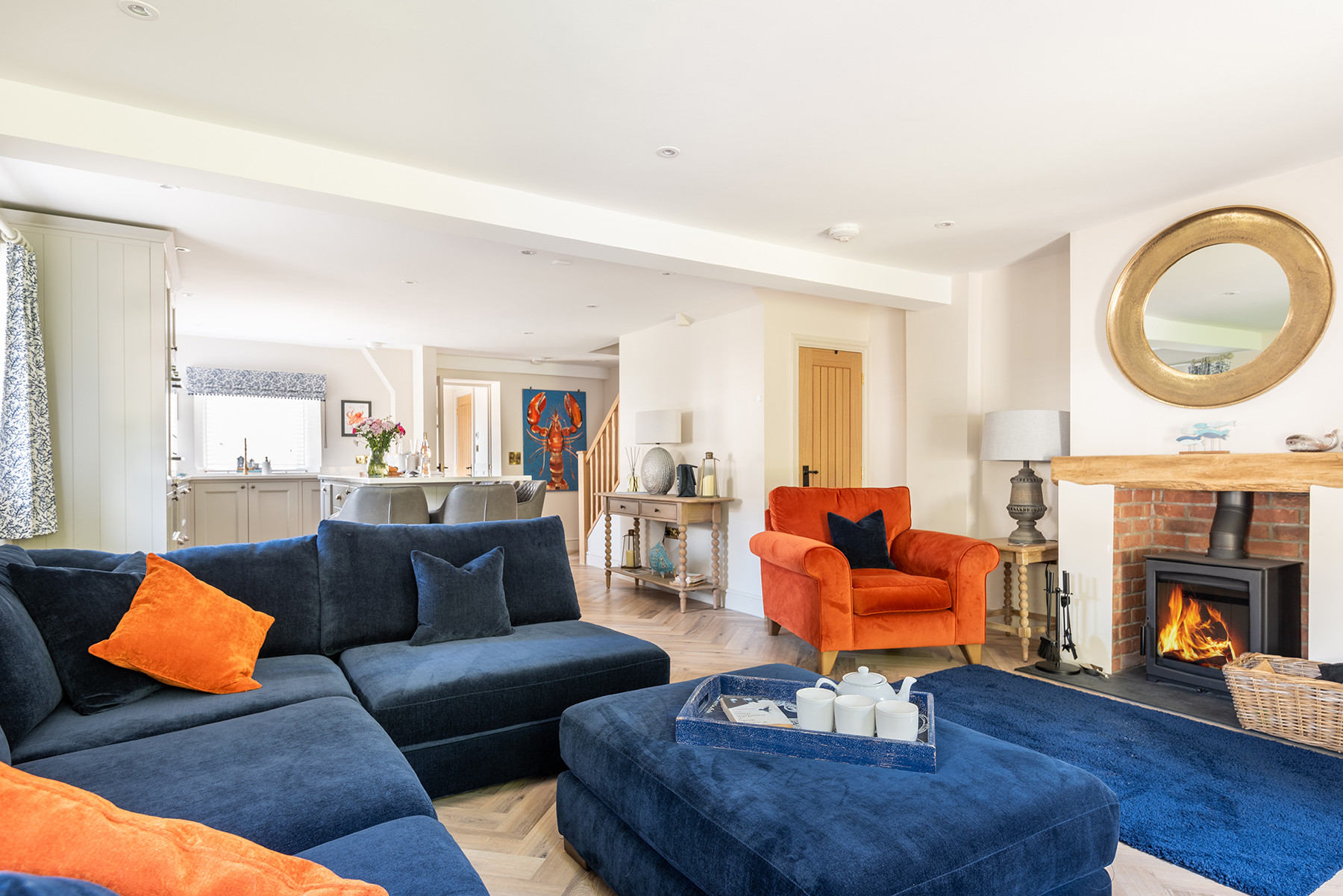 Large, comfortable sofas with pouffes for ultimate lounging comfort around the log burner.