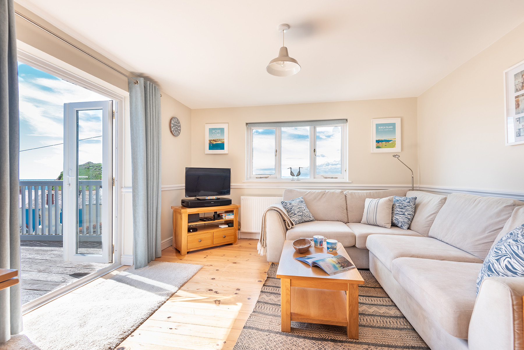 The comfortable lounge area, leading out to the decked terrace.