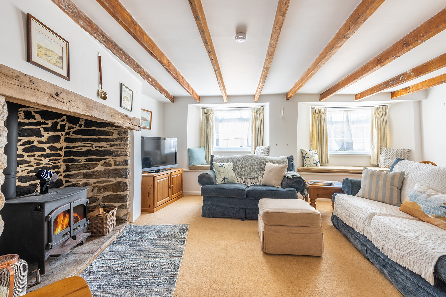 Another view of the lovely lounge with log burner