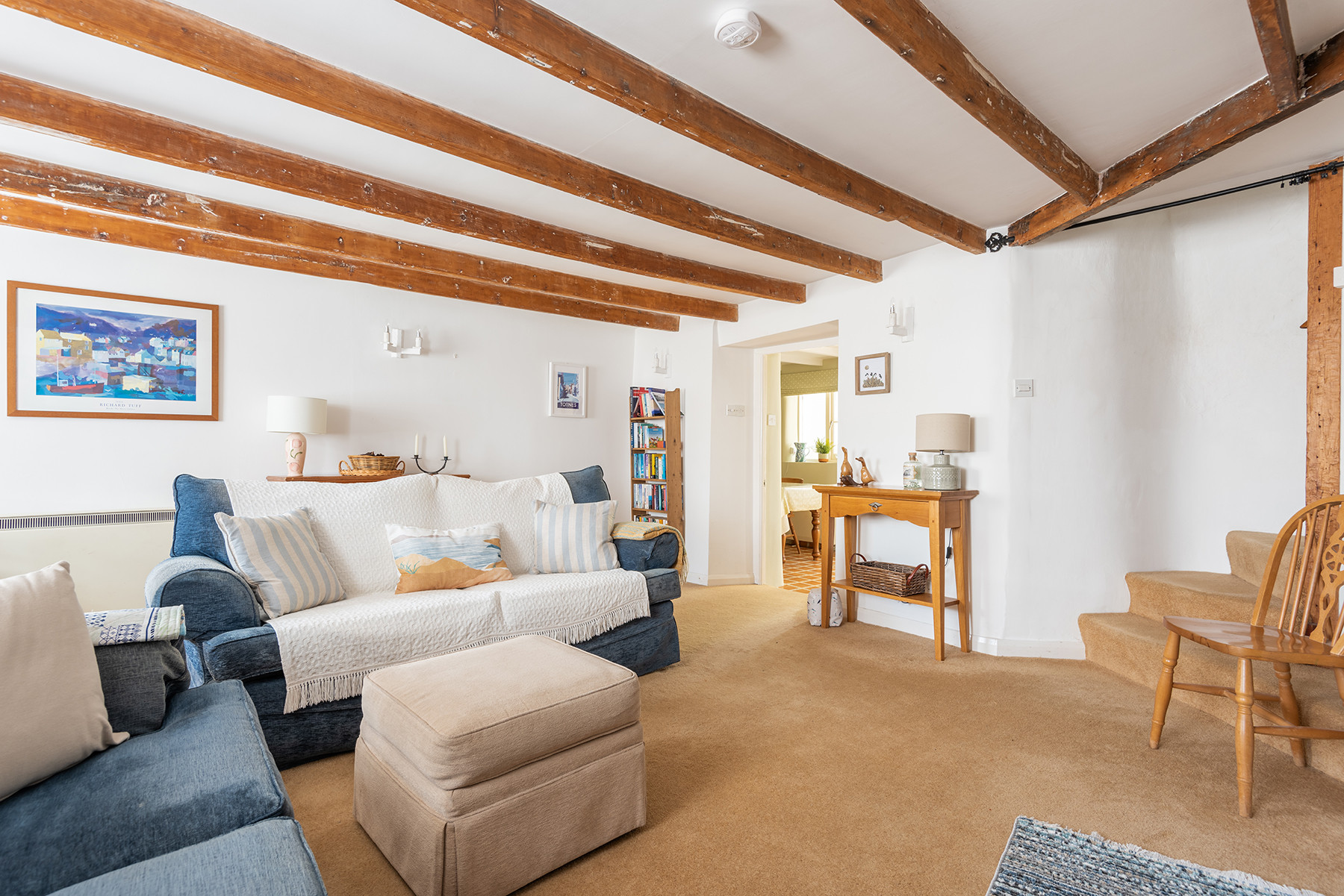 The lounge looking into the kitchen diner and bottom of he stairwell