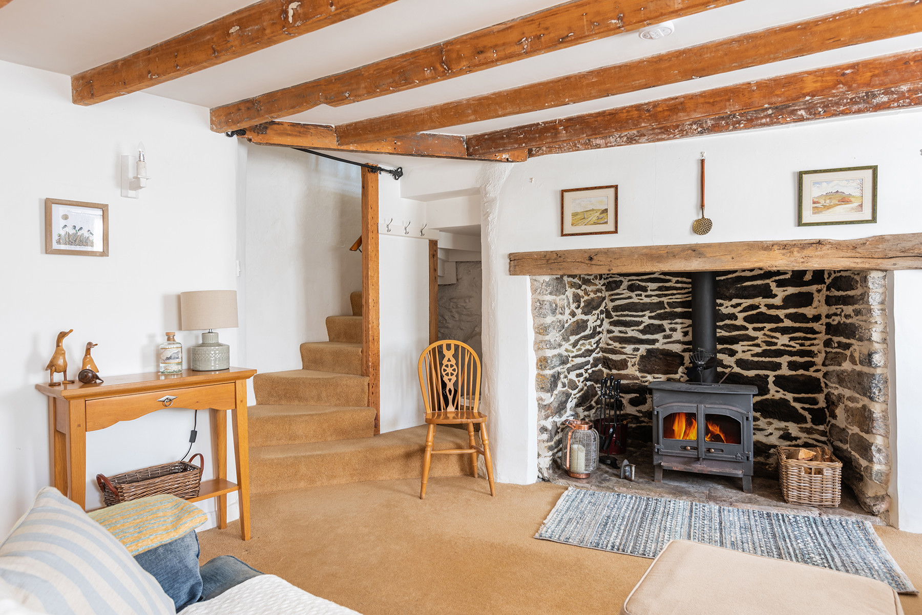 The winding stairs to the first floor and the log burner