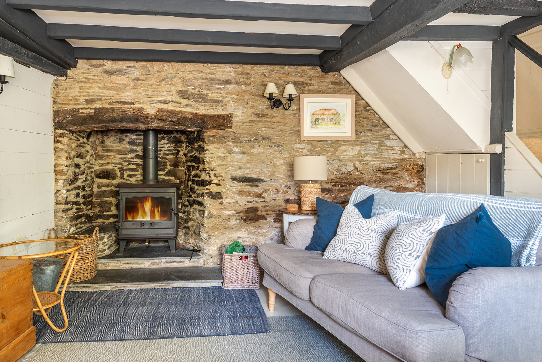 Another view of the quaint fireplace with wood burner