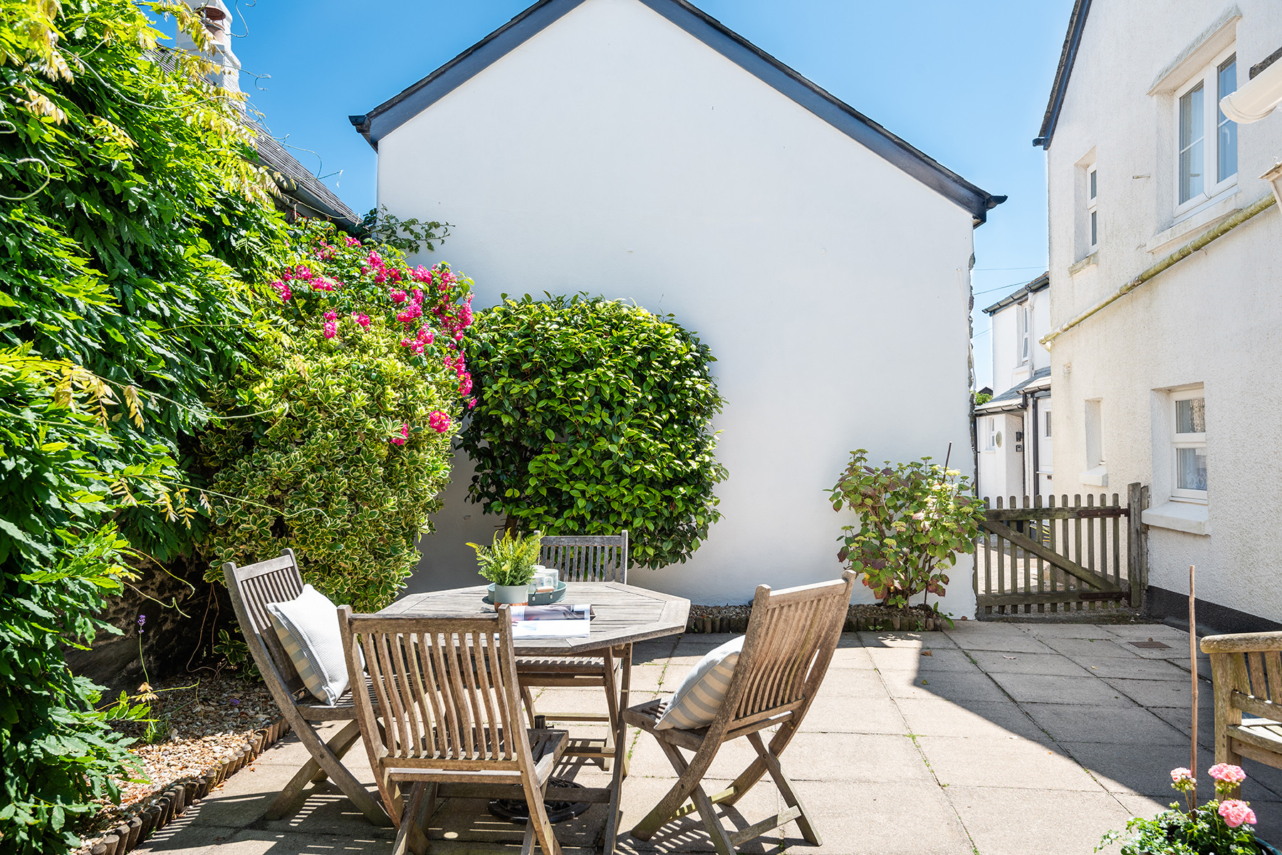The sunny courtyard opens out opposite the village green