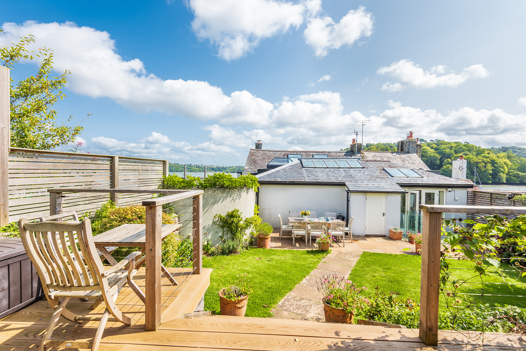 Studios decked terrace with seating and steps to main back garden