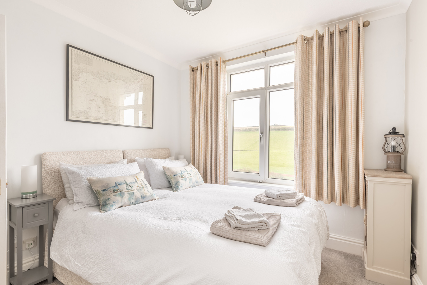 The master bedroom with countryside views and views of the sea from the side window.