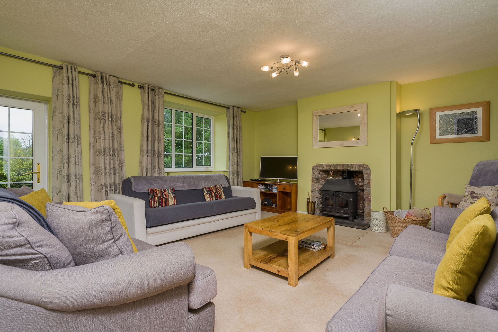 The living room with log burner, countryside views and access to the patio