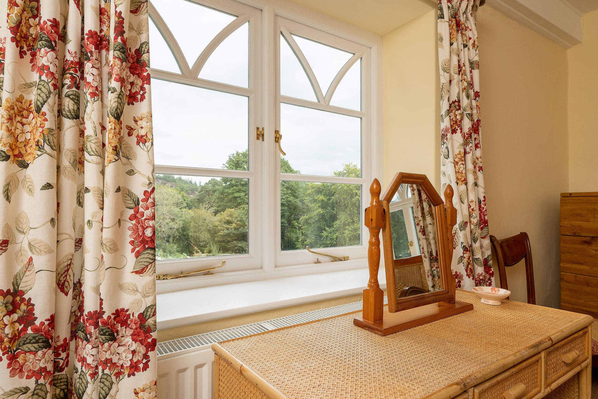 Bedroom one enjoys views over the grounds.