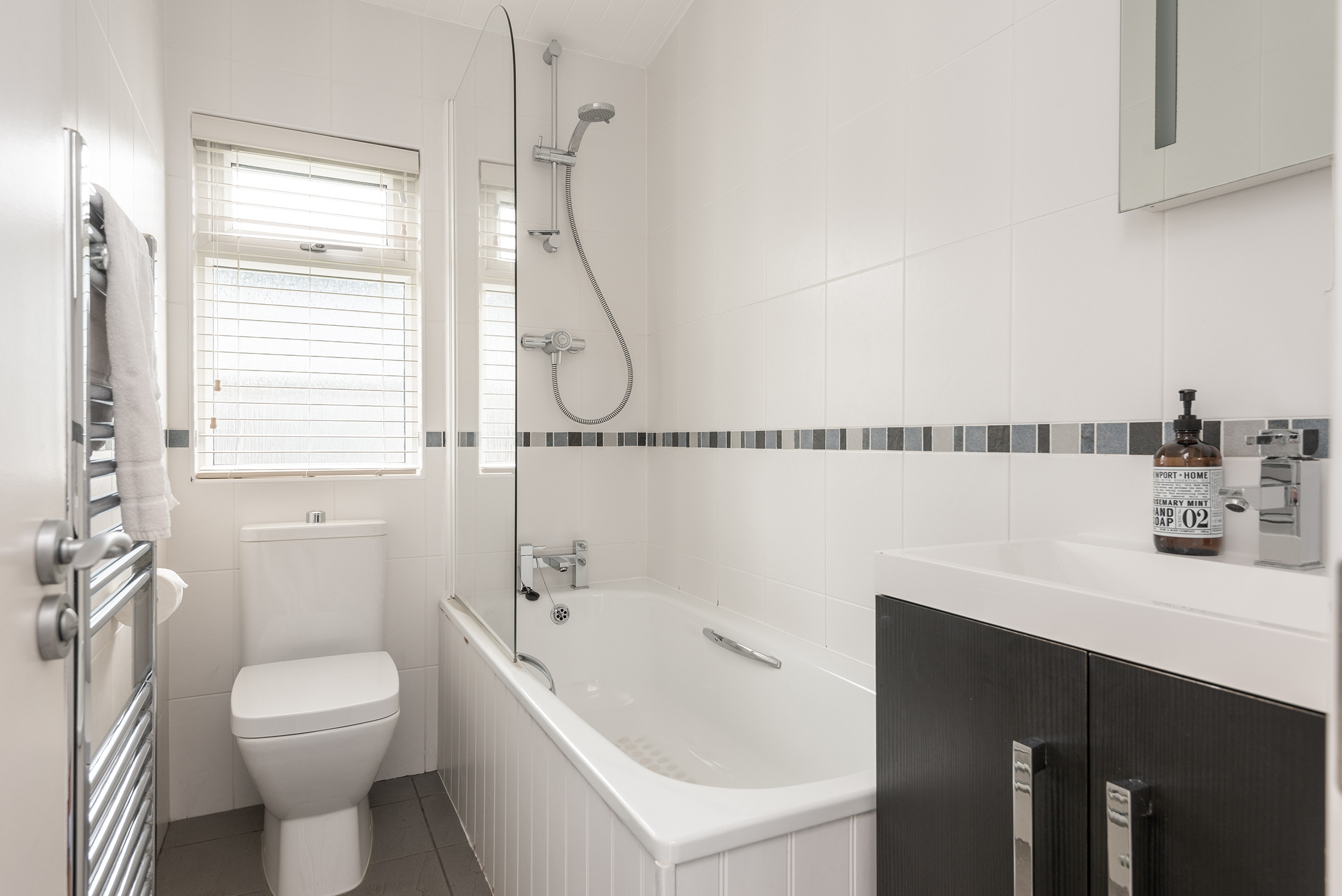 Family bathroom with over head shower.
