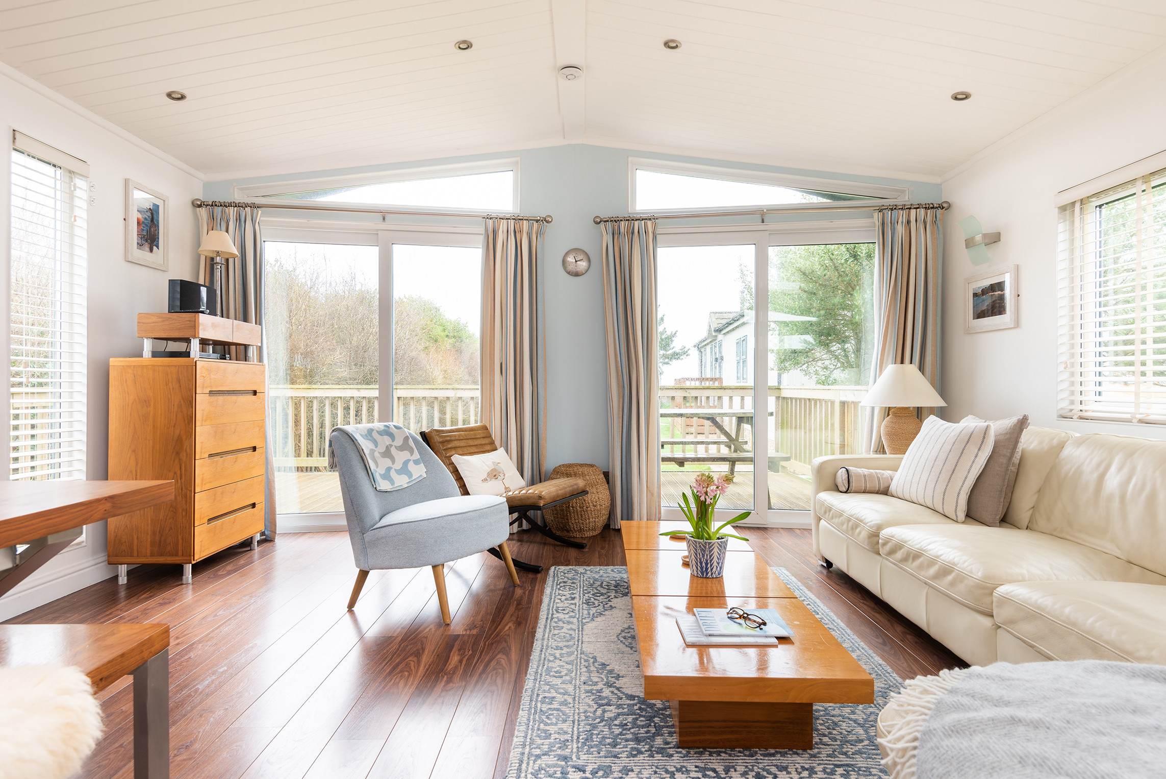 The sitting room area with ample seating. French windows leading out to the decking.