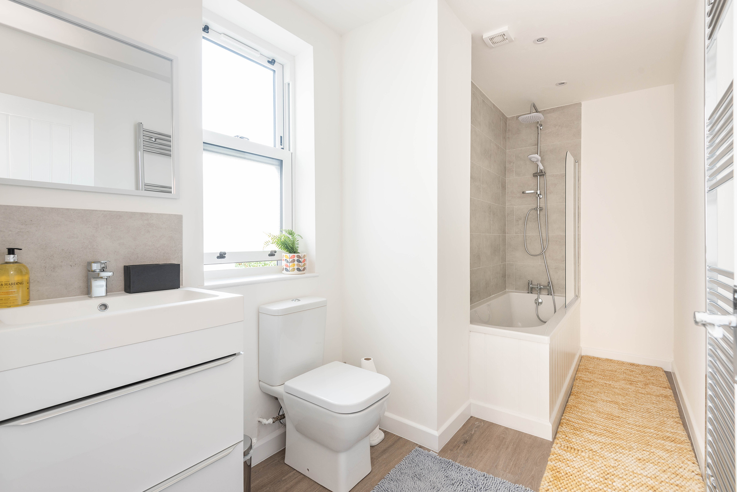 Family bathroom with bath and overhead shower
