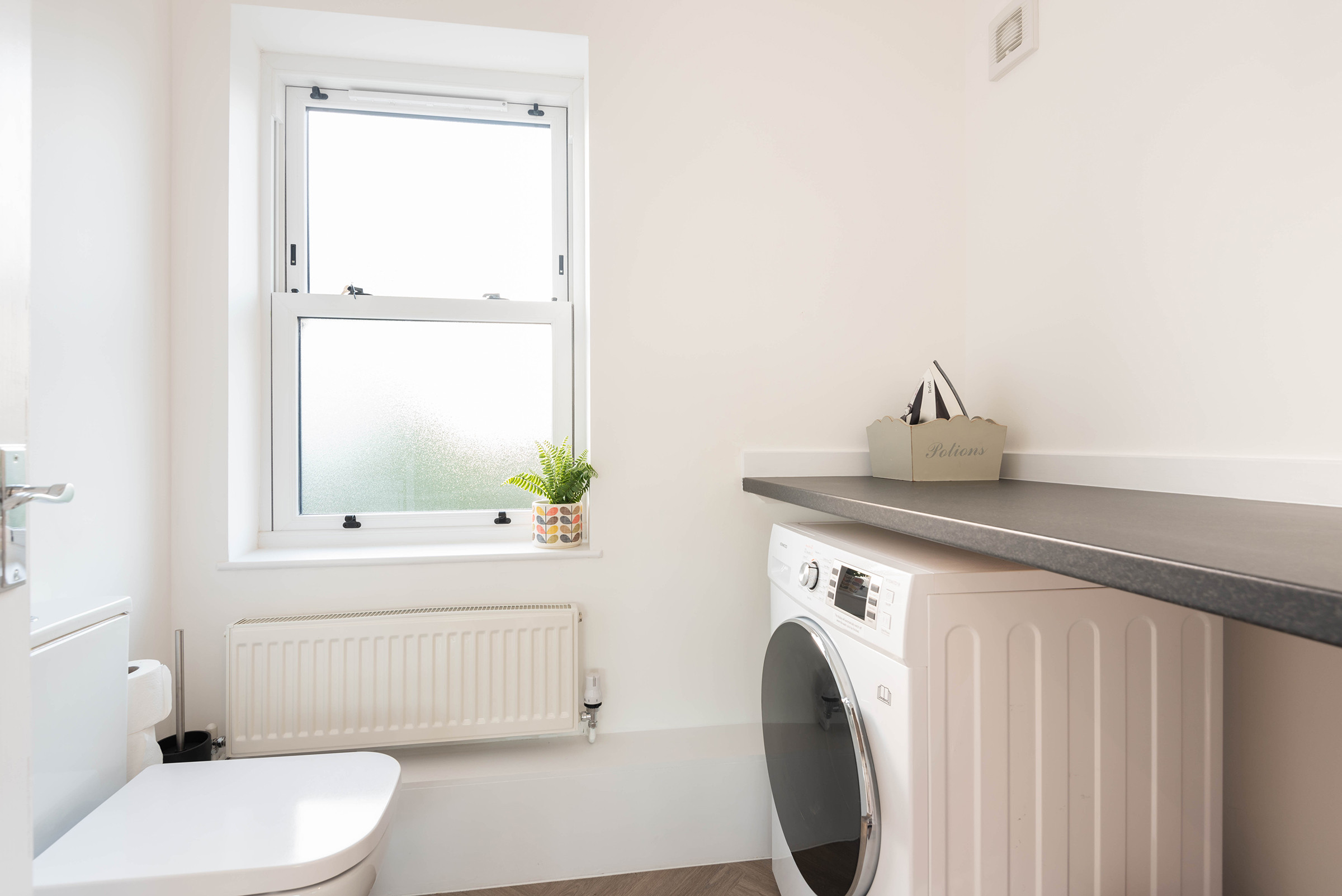 Laundry room with washer/tumble dryer and WC