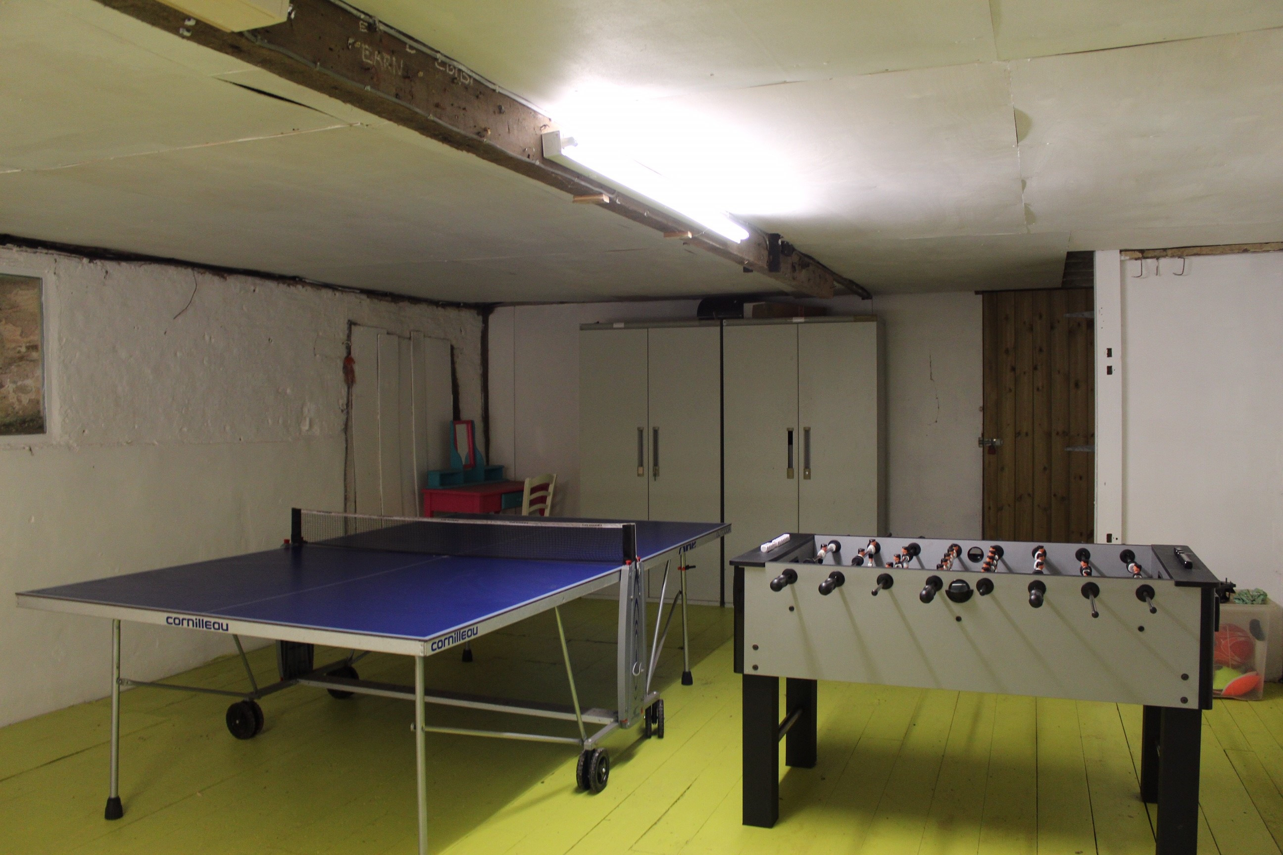 The lower barn accessed from the kitchen houses a table tennis and table football table